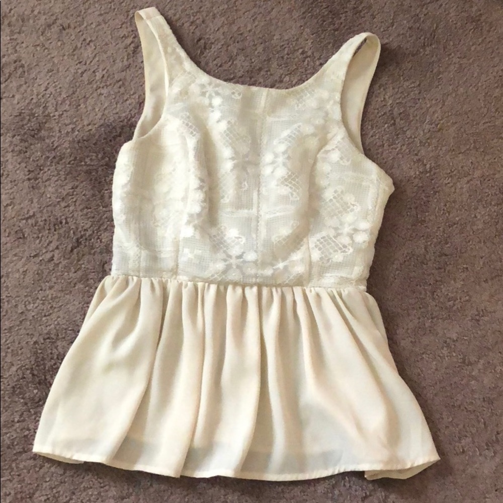 Cream colored tank top blouse.